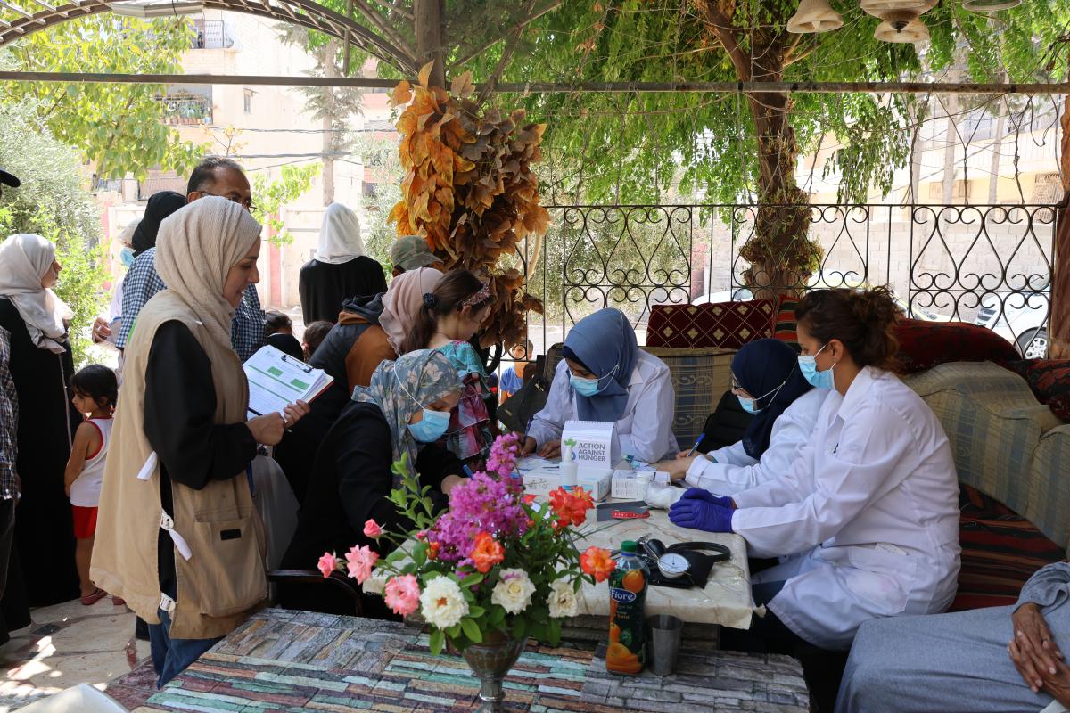 Syrian patients receiving medical care from a mobile clinic supported by Action Against Hunger